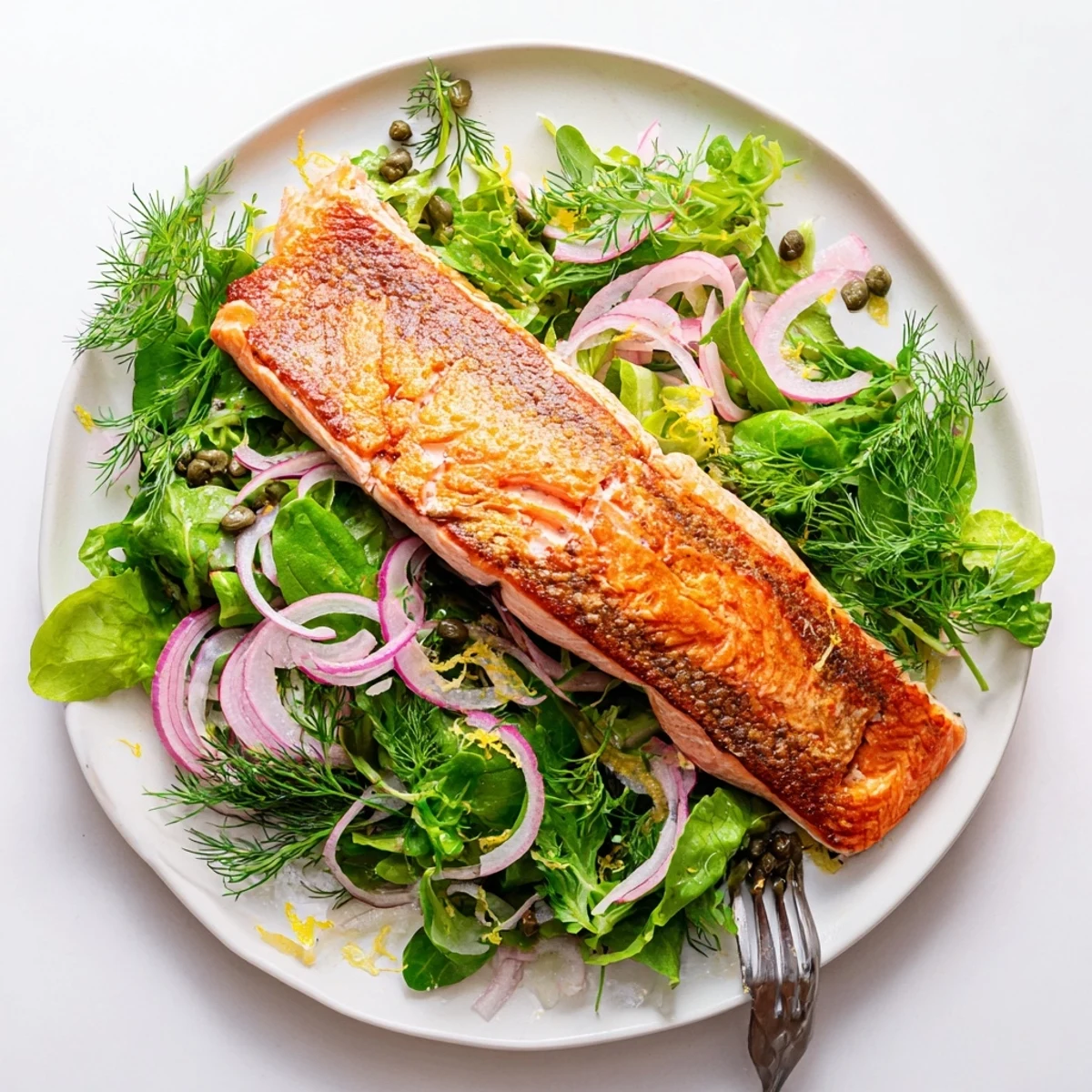 Perfectly cooked crispy skin Tasmanian Atlantic salmon served over fresh lemony herb salad greens