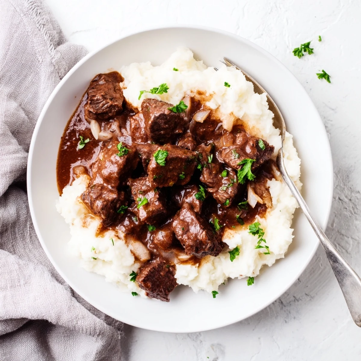 Tender beef tips swimming in rich brown gravy alongside buttery mashed potatoes for a comforting dinner