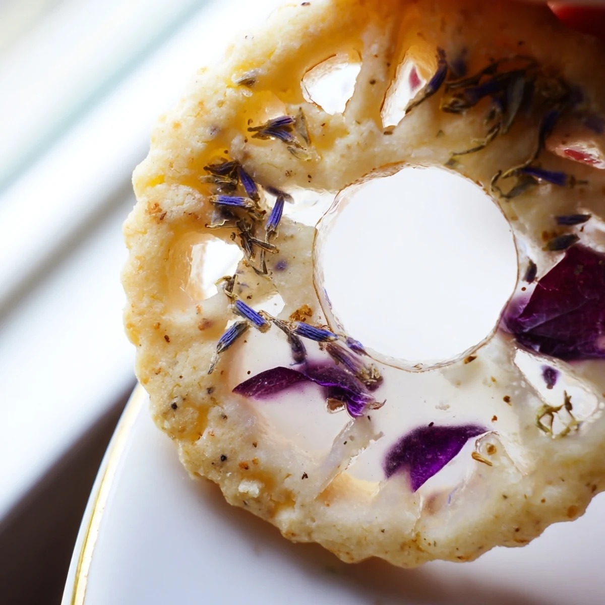 Earl Grey stained glass floral cookies with translucent candy centers and pressed violet petals