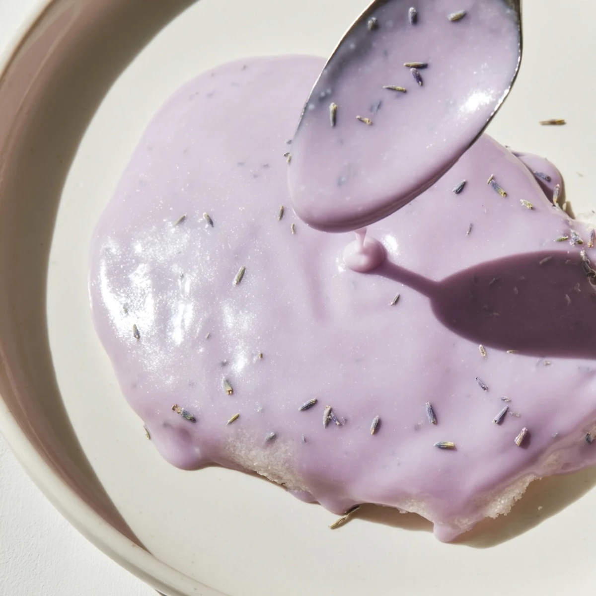 Smooth purple lavender glaze dripping down a freshly baked scone top