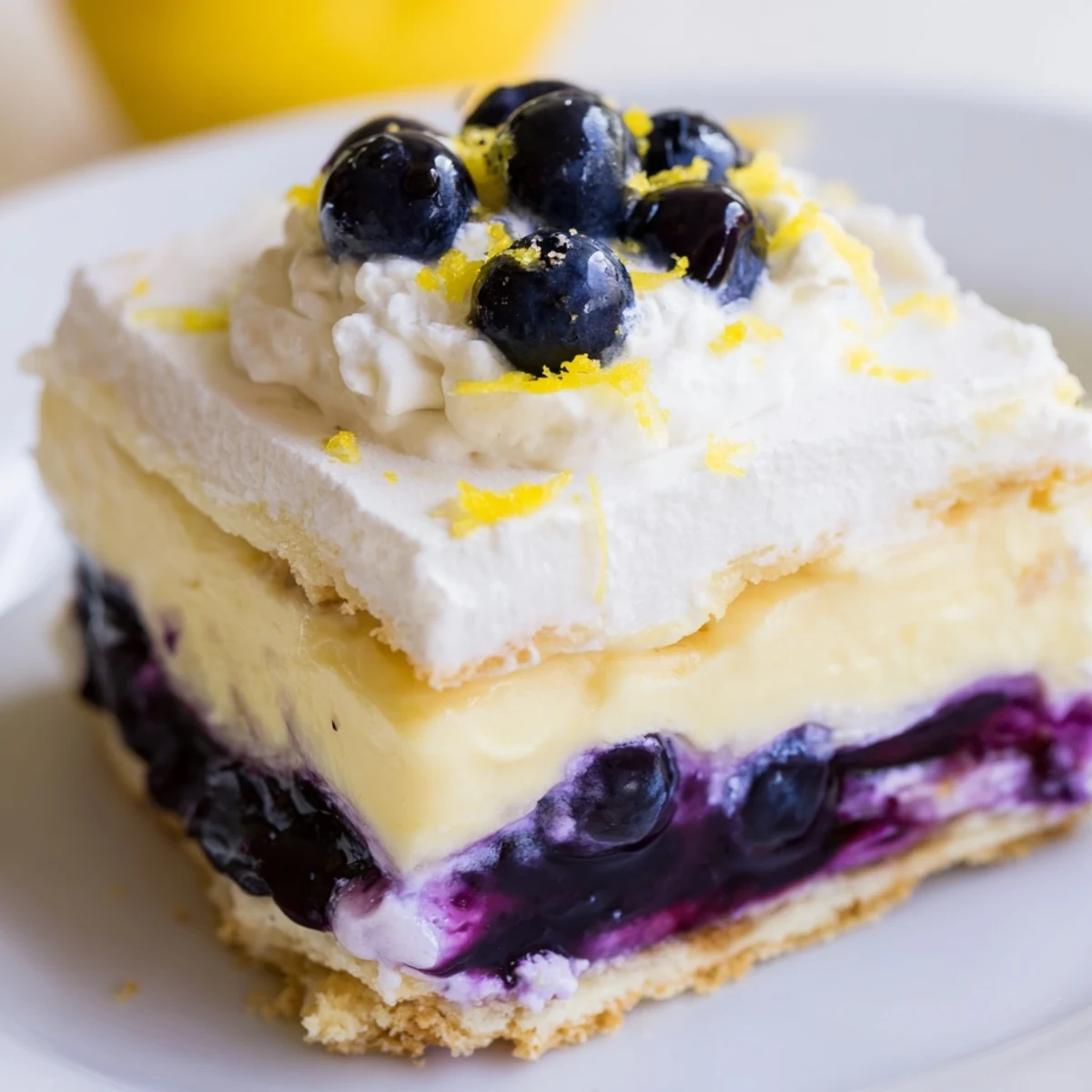 No-bake lemon blueberry lasagna with whipped cream topping and fresh berry garnish