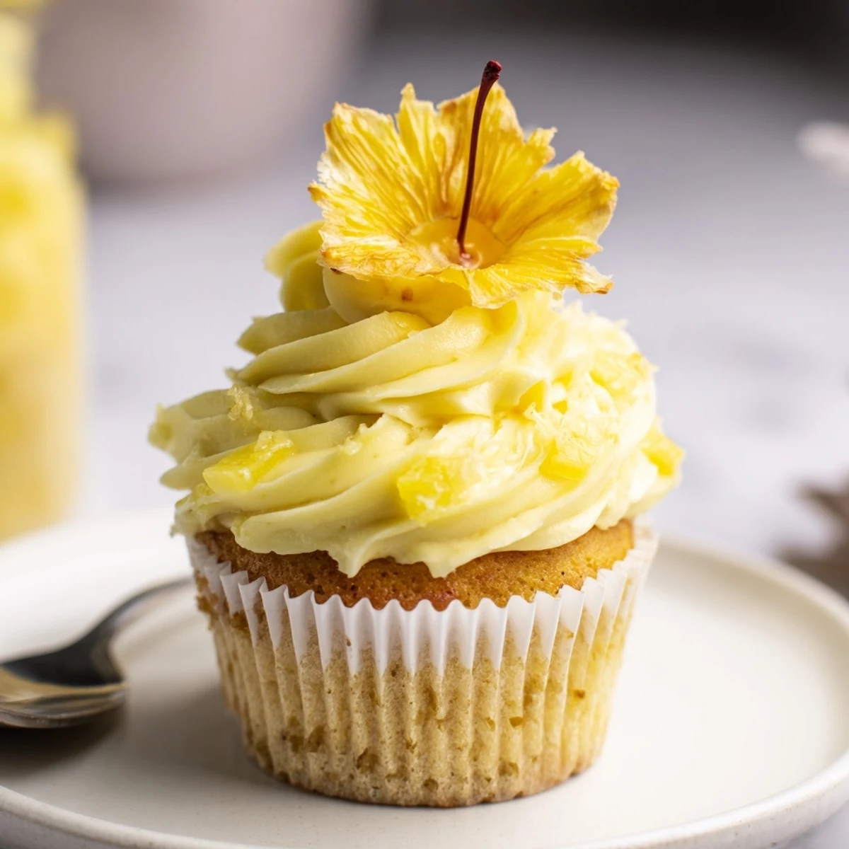 Dole Whip Cupcakes Recipe showing fluffy pineapple cupcakes topped with creamy frosting.