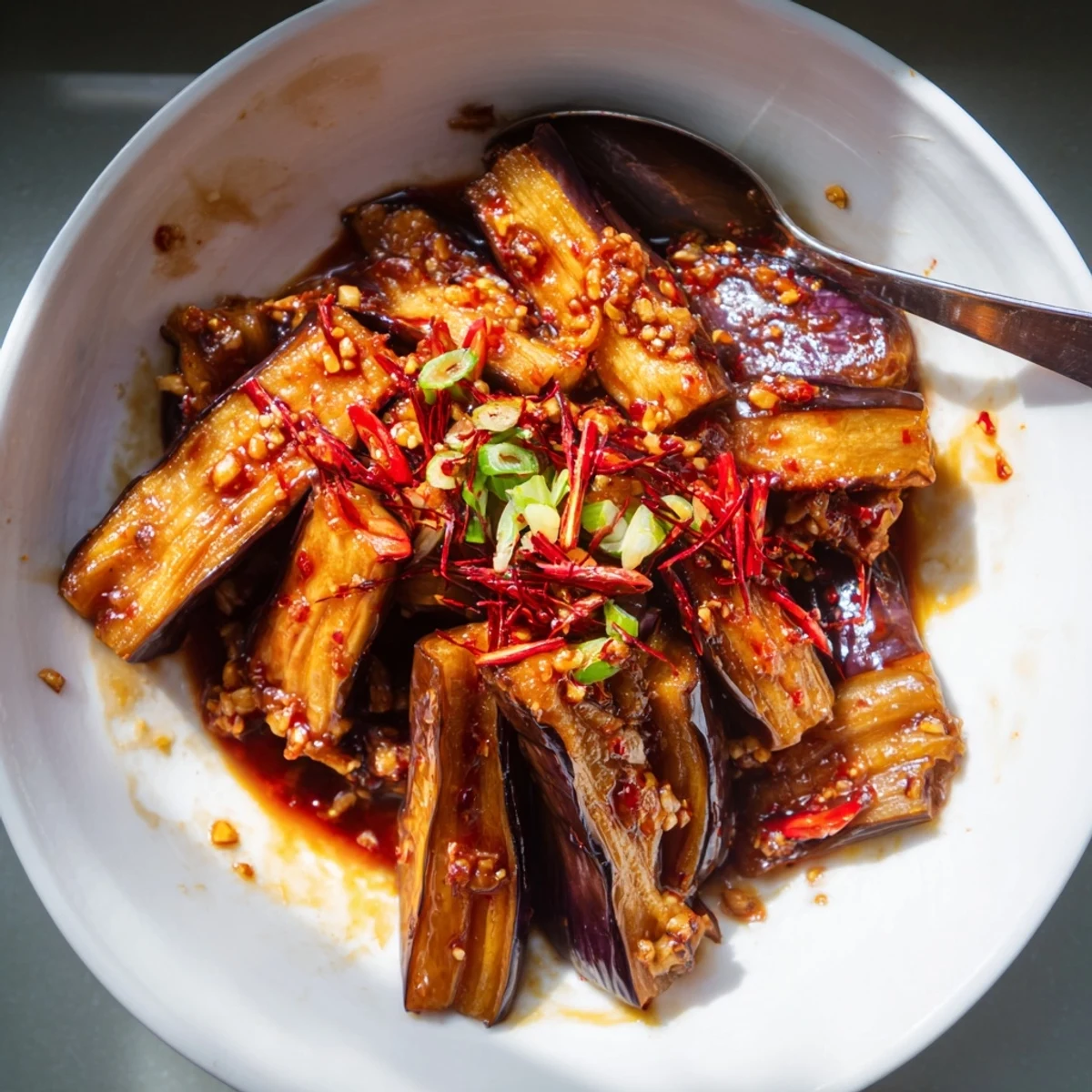 Steaming Sichuan Style Braised Aubergines piled over fluffy jasmine rice, aromatic