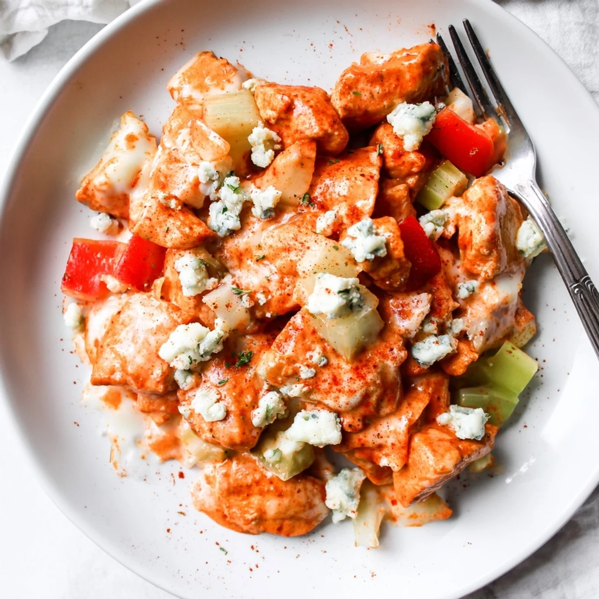 Keto Buffalo Chicken Skillet sizzling in pan with creamy sauce and parsley