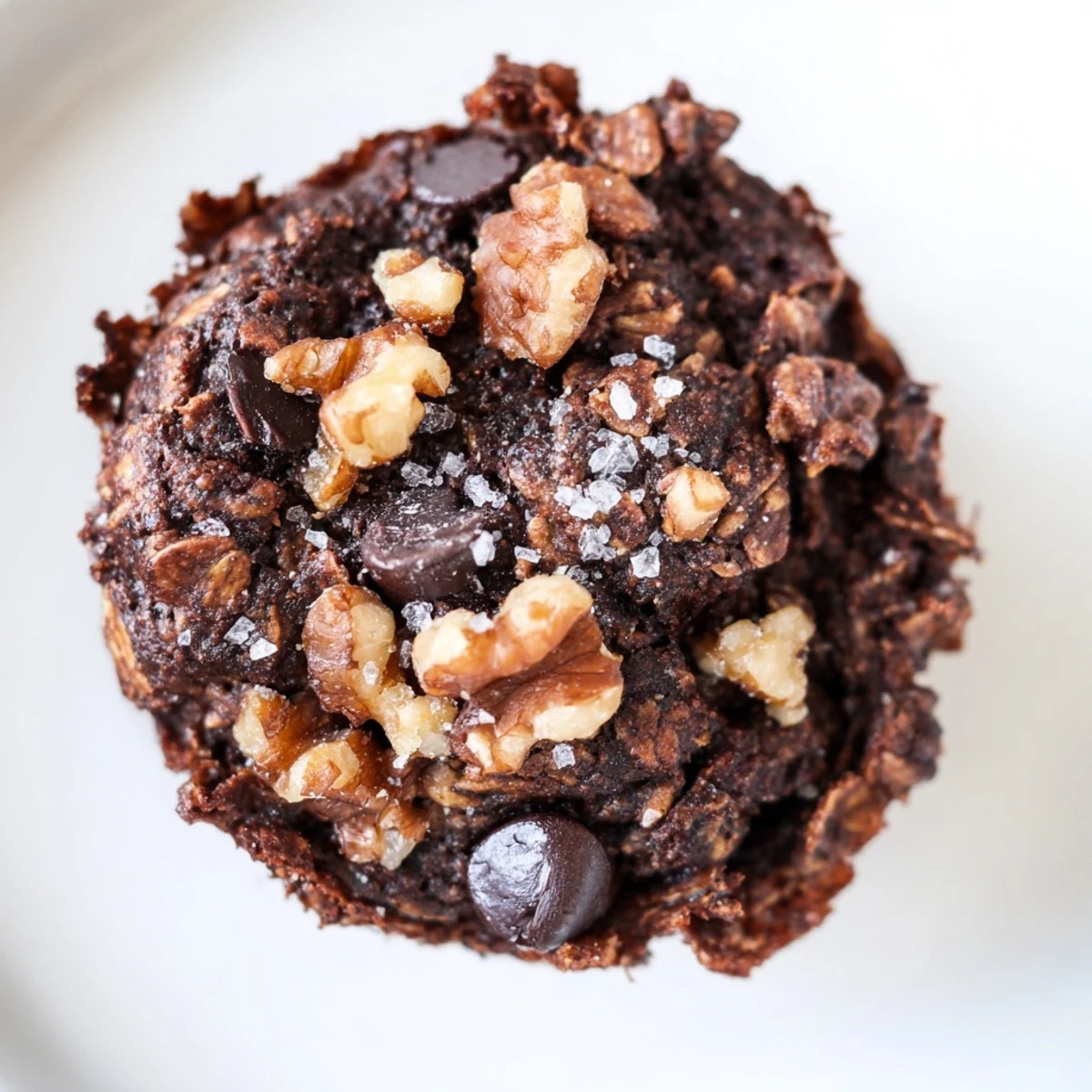 Fudgy dark chocolate oatmeal cupcakes cooling on a wire rack with sea salt sprinkles