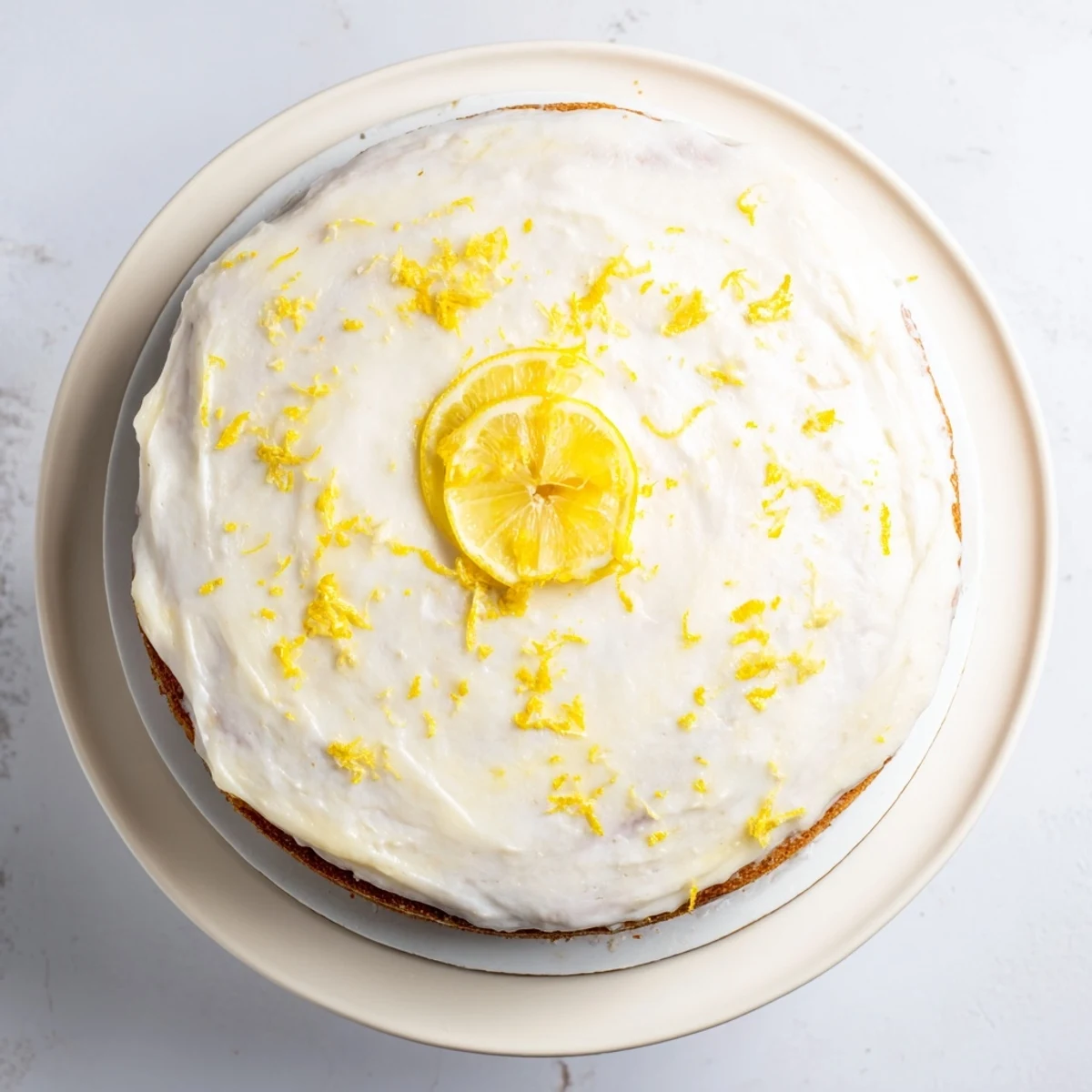Festive lemon birthday cake with fluffy layers and creamy lemon frosting on a white serving plate