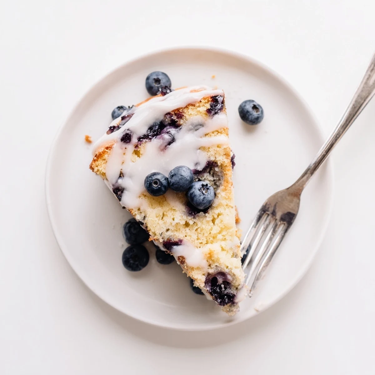 Homemade lemon blueberry cake with tangy glaze and plump blueberries throughout