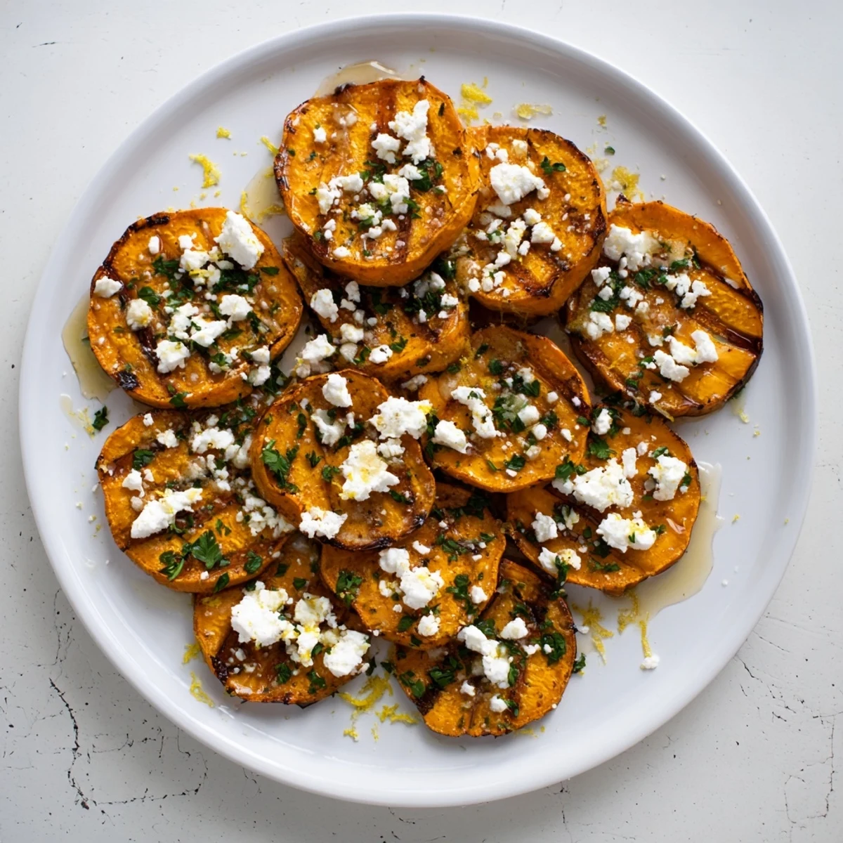 Golden roasted sweet potato rounds topped with crumbled feta and sweet honey drizzle