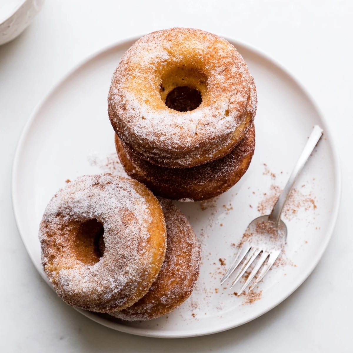 Warm Banana Donuts cooling on a wire rack, golden edges and soft centers.
